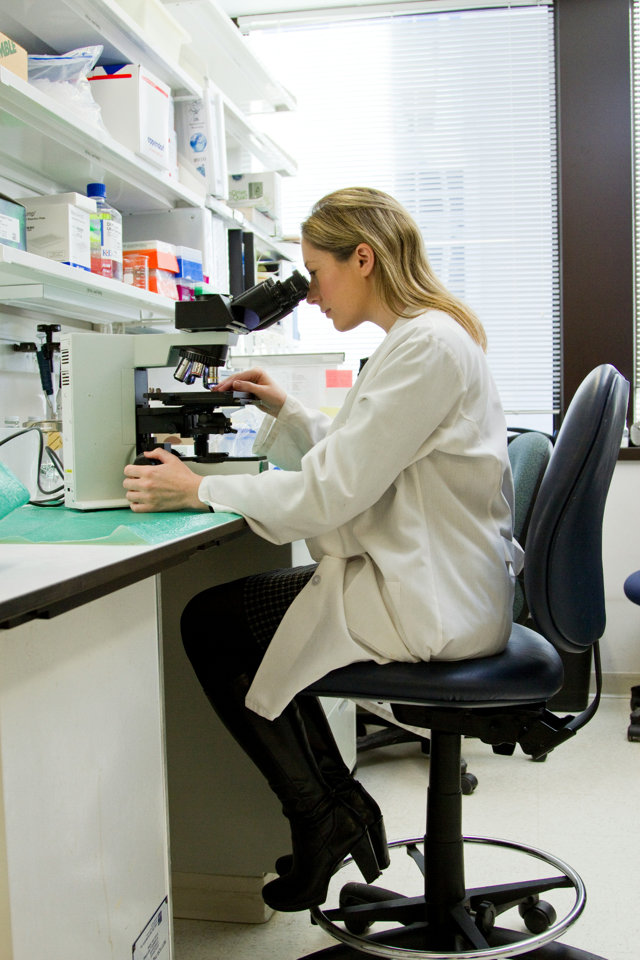 Research scientist examining a sample through a microscope